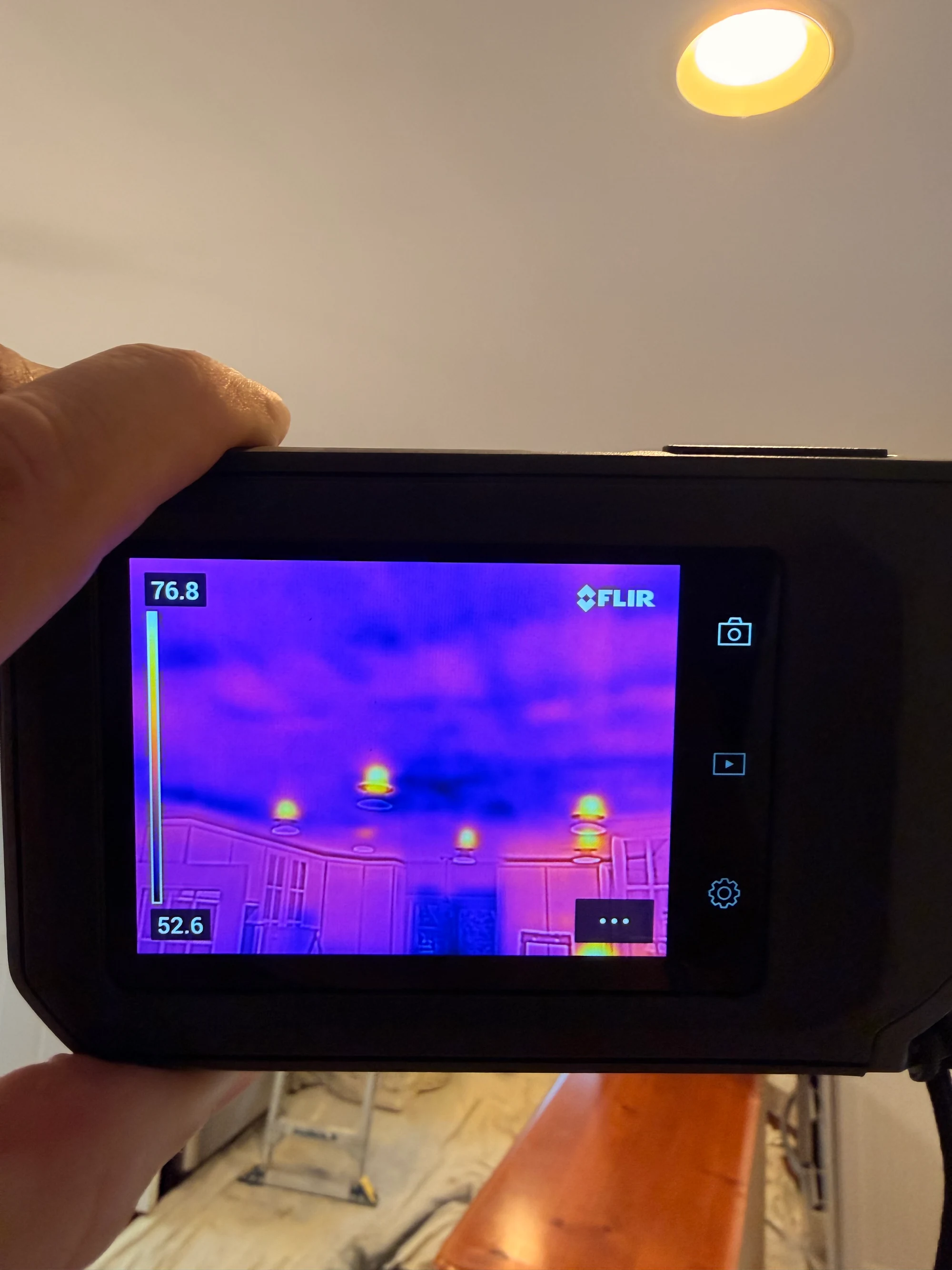 Thermal imaging camera showing hidden moisture in a ceiling during a water damage inspection