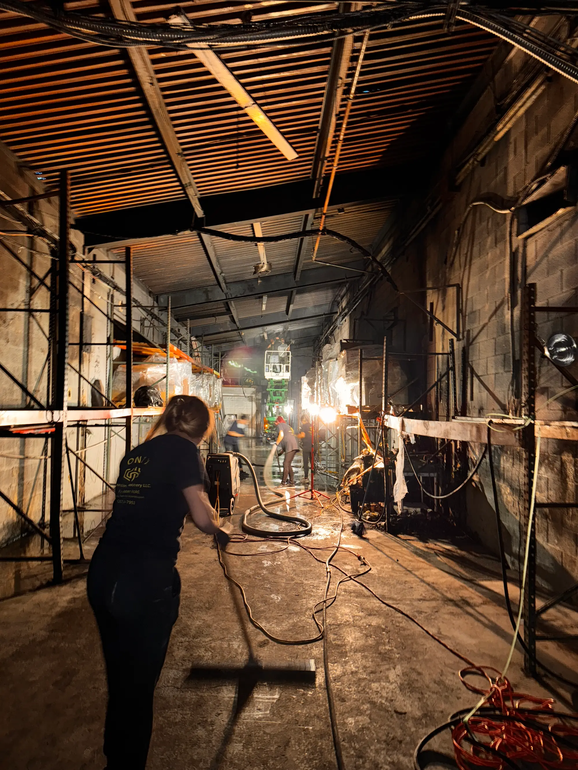 Onyx crew member working from scaffolding during a commercial warehouse restoration